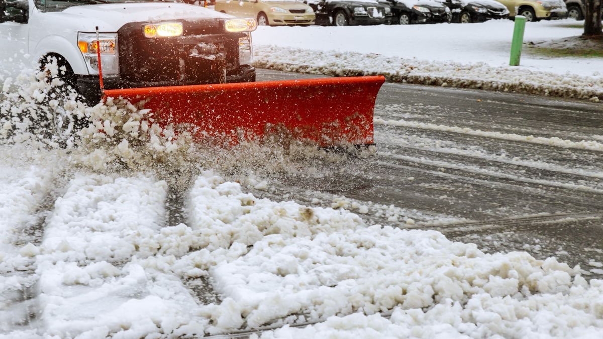 Snow plowing equipment clearing a parking lot